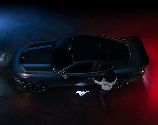 2024 Ford Mustang® Dark Horse™ model with a driver approaching the vehicle | Harlan Ford, Inc. in Okmulgee OK