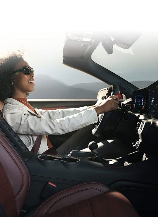 Person sitting in the driver’s seat of a 2024 Ford Mustang® convertible | Harlan Ford, Inc. in Okmulgee OK