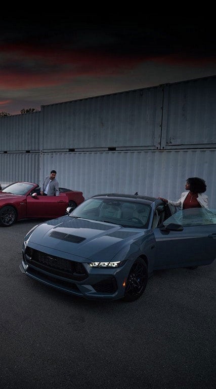 Two people exiting their parked 2024 Ford Mustang® coupe and convertible | Harlan Ford, Inc. in Okmulgee OK
