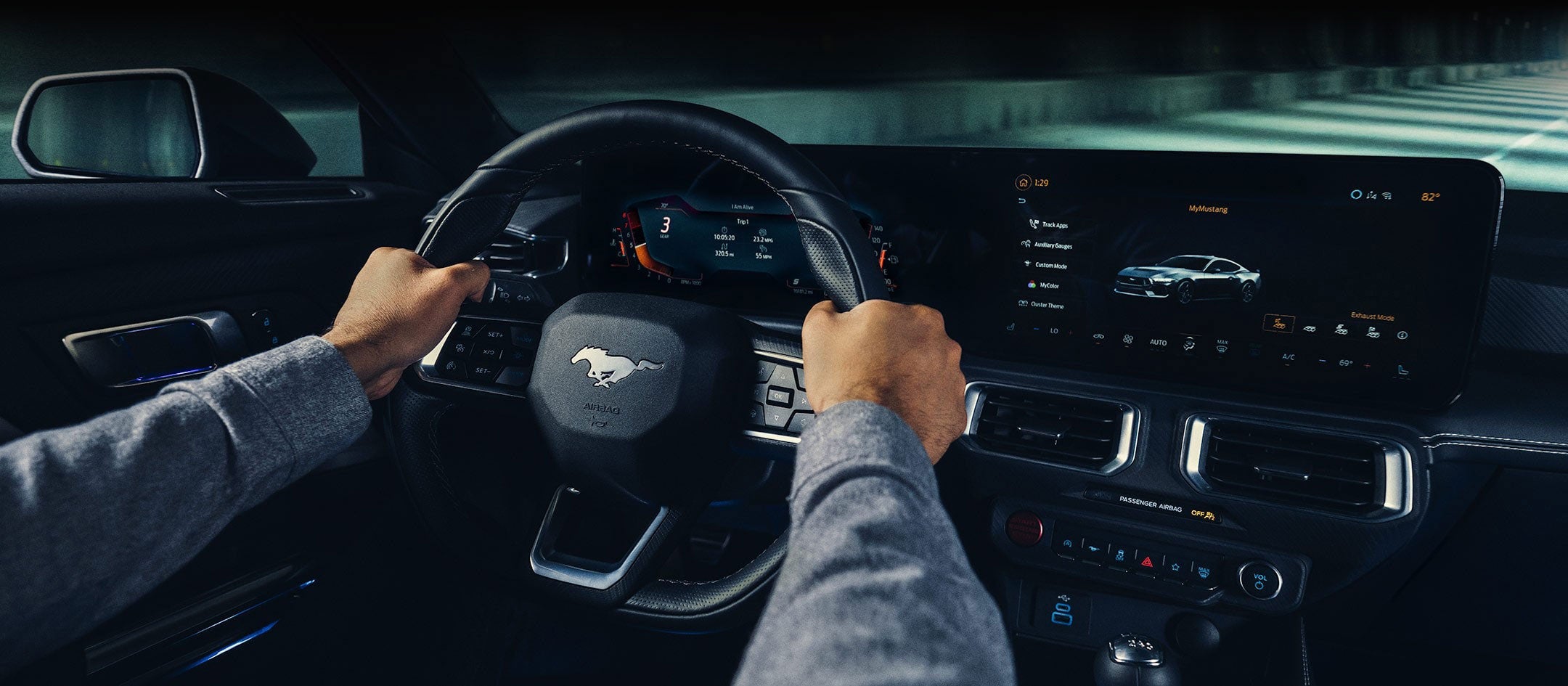 A 2024 Ford Mustang® model interior with a person driving | Harlan Ford, Inc. in Okmulgee OK