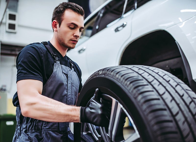 Technician checking a car tire